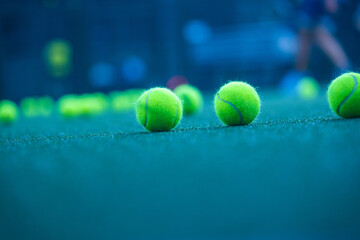 Padel balls on court during sunny day, clean and minimalistic image for sports websites, blogs, and...
