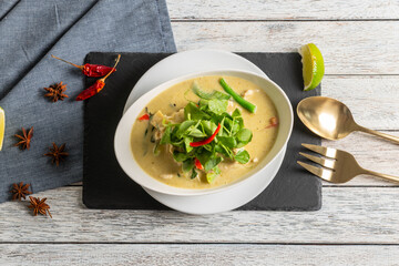 Coconut Curry Soup With Fresh Herbs and Lime Wedge