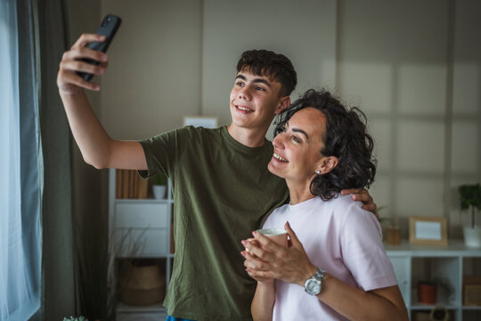 happy mother and son take a self portrait or video call on cellphone