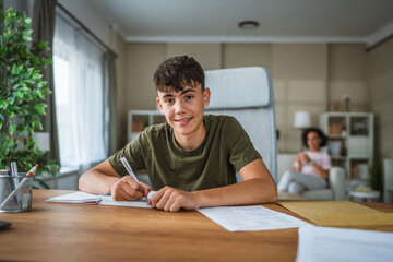 portrait of teenage boy sit and study, prepare for exams at home