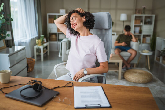 Mature curly hair woman stretching at home office happy and relax