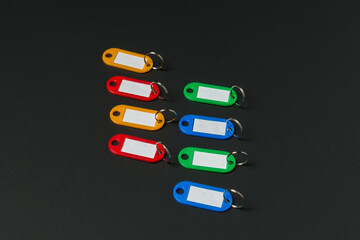 Colorful Key Tags Arranged on a Dark Surface