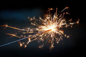 Sparklers burst with fiery light against dark
