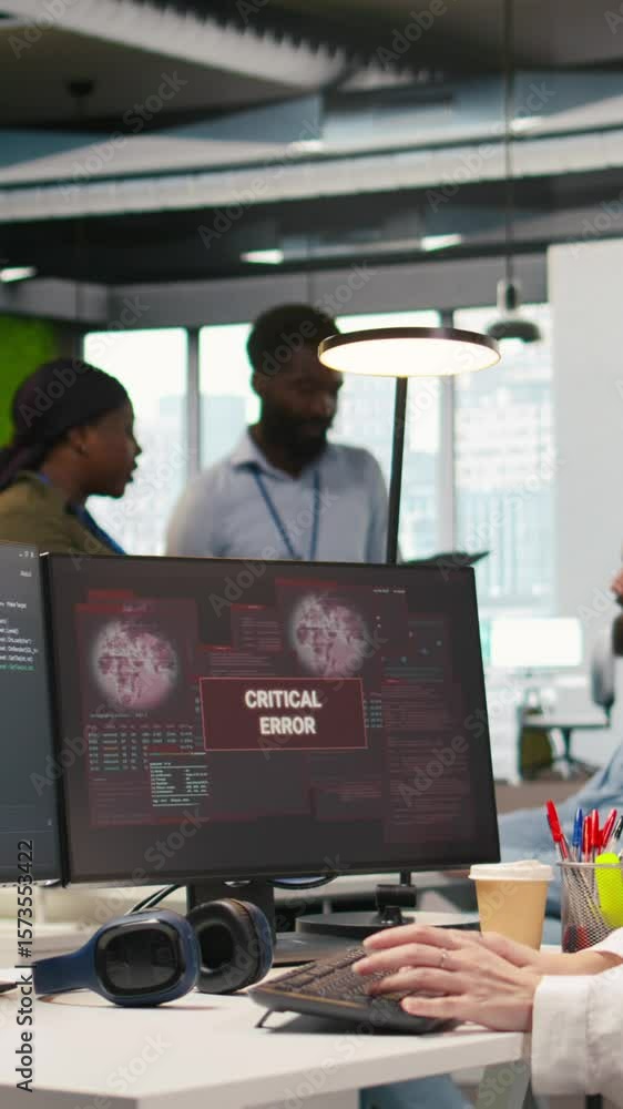 Poster vertical video female programmer in startup office struggling to fix application errors while coding