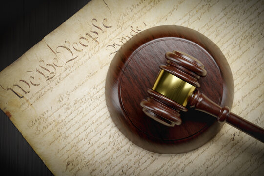 United States Constitution and Gavel Resting on Table.