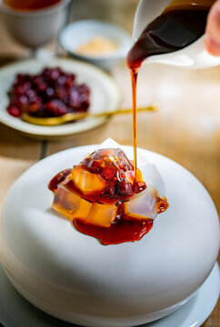 Japanese Brown Sugar Jelly Dessert with Kuromitsu Syrup.

Close-up of traditional Japanese kanten jelly topped with rich kuromitsu brown sugar syrup. A refreshing and elegant wagashi dessert, often en