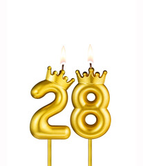 Golden number 28 birthday candle on white background