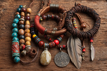 Unique handmade jewelry collection featuring bracelets and necklaces on rustic wooden background