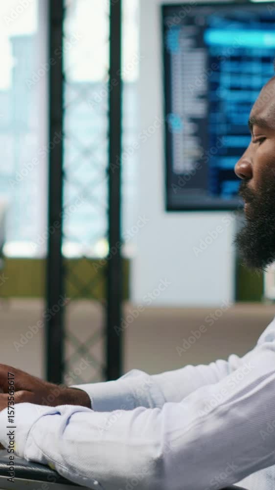 Fototapete Vertical video Computer scientist with paraplegia in office automating repetitive tasks with AI scripts. IT professional in wheelchair using artificial intelligence to speed up feature implementation