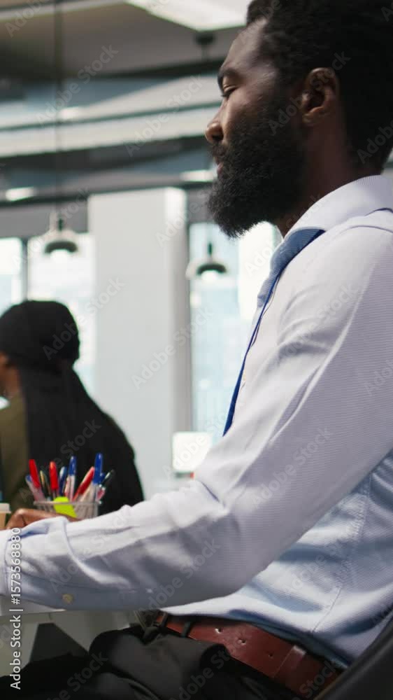Poster vertical video system administrator at office desk developing software applications using ai automat