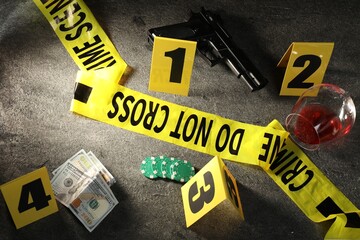 Forensic expert. Yellow crime scene tape, markers and evidences on grey table, above view