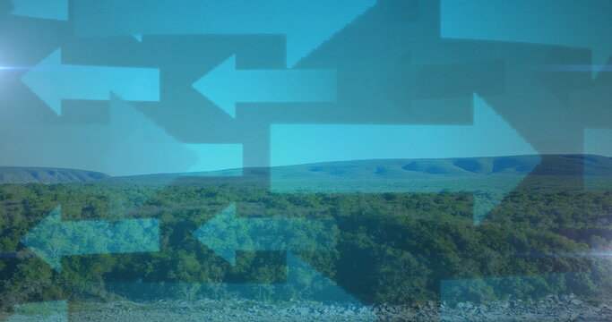 Fototapeta Pointing translucent blue arrow icons overlaying riverbed hills below sky, navigation symbols