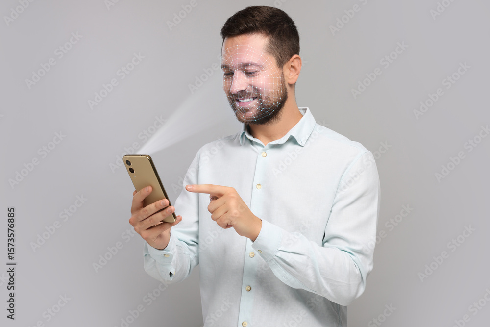 Poster man unlocking his smartphone with facial recognition app against light grey background. biometric ve