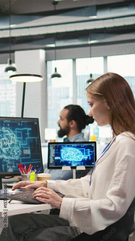 Poster vertical video junior dev in office relies on ai tech to run tasks across multiple devices, monitori