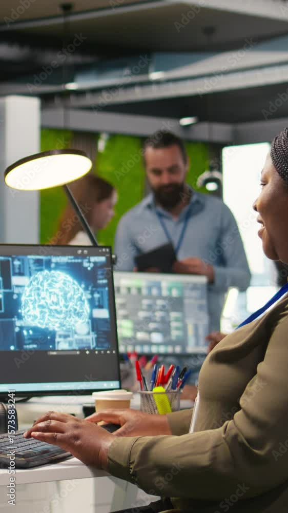 Poster vertical video female technician using computer to write code, developing machine learning apis. afr
