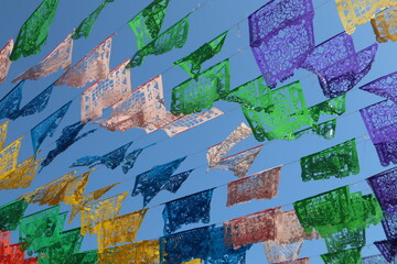 Colorful papel picado traditional mexican colorful banners blowing in the wind in rosarito mexico