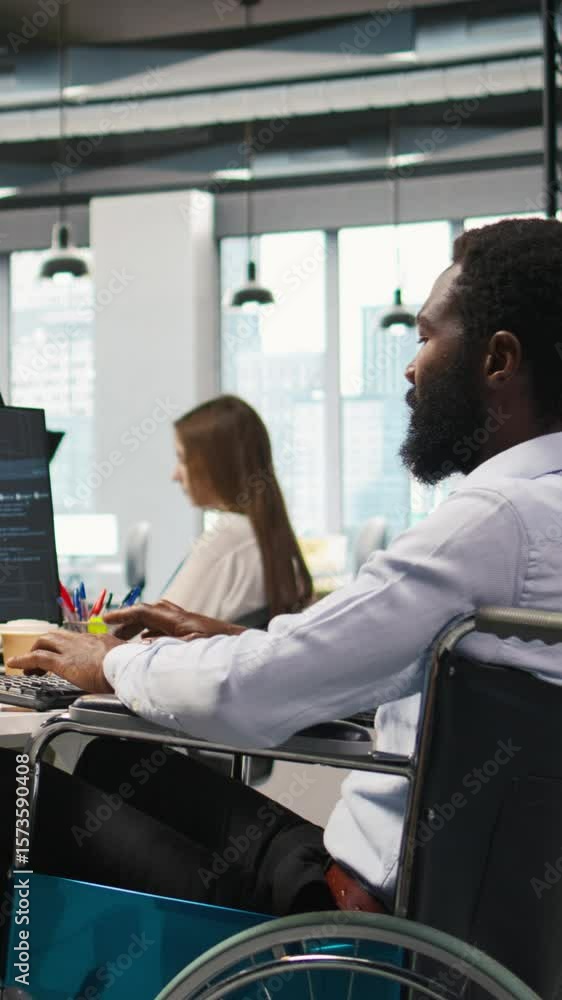 Poster vertical video it professional in wheelchair in inclusive office developing software applications us