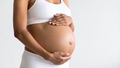 Close-Up Belly Portrait &ndash; Hands Holding Pregnant Stomach in Studio Light
