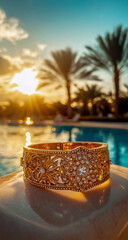 A detailed closeup of an ornate, diamond-encrusted gold bracelet lying beautifully on the edge of a stylish poolside table, set against the backdrop of an elite luxury resort.