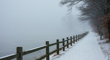 Snowy path in foggy forest