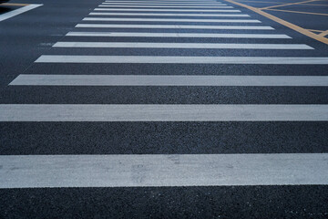 Markings of a pedestrian crossing on asphalt road. Roads infrastructure and transport