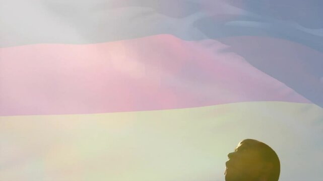 Male athlete catching falling soccer ball sitting on turf and juggling for ball control training