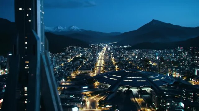 Night city skyline with mountain backdrop