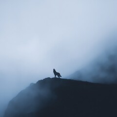 A lone wolf howls atop a misty mountain ridge, enveloped by dense fog and a moody, blue-toned sky.