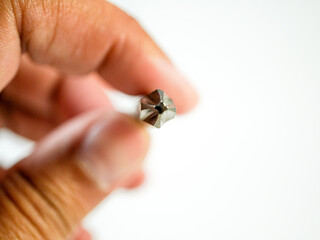 Screwdriver bit being held in hand demonstrates repair, assembly, maintenance concepts for diy...