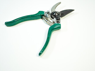 Pruning shears with green handles are set against a crisp white background for gardening and yard...