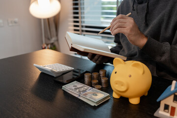 a man is calculating the money from his savings account to buy a house, this man is calculating his...