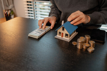 a man uses his savings to buy his dream home, this man plans his finances to buy a home, he uses...