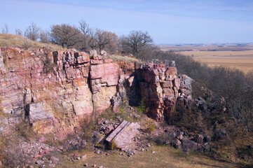 sioux quartzite cliffs and prairie surrounded by farmland at blue mounds state park of minnesota
