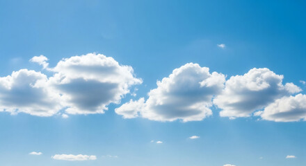 Fototapeta premium Sky of Serenity: The endless expanse of a clear blue sky is punctuated by fluffy, cumulus clouds, forming a picturesque display of nature's beauty, radiating feelings of peace and tranquility.