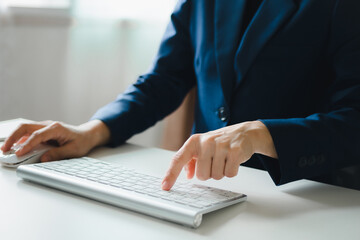 Woman's hands are using a computer keyboard and mouse to Searching for information. business working woman data search technology	