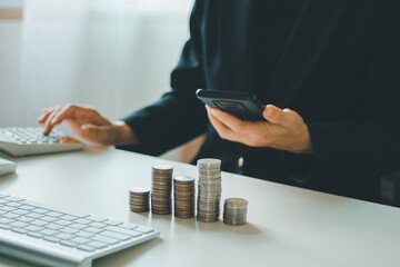 young woman using calculator calculating monthly home expenses, taxes, bank account balance and credit card bills payment, concept saving money.	