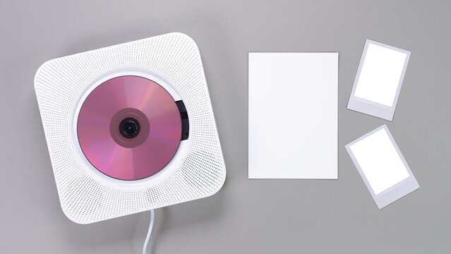 Compact Disc Player and Blank Mockup Cards on Grey Surface. Minimalist Music and Memory Setup.