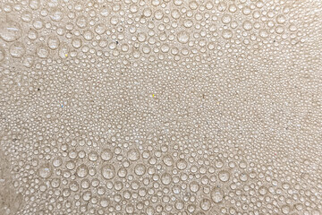 Abstract background of water droplets on a smooth surface. Macro shot showing texture, pattern, and...