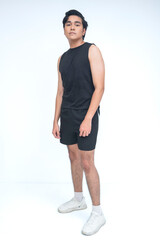 Filipino man stands with a neutral expression and subtle swag, one foot forward in a confident and...