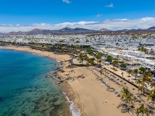 Aerial view of Puerto del Carmen, Lanzarote, showcasing coastal buildings and clear blue waters