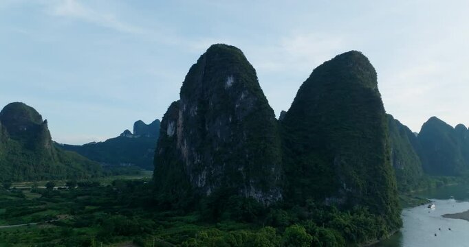 Panoramic drone shot around the Yuanbao Mountains, summer day in Xingping, China