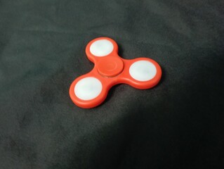 A red fidget spinner is a small toy designed to be spun between the fingers. It became very popular...