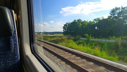 Train window view of countryside tracks