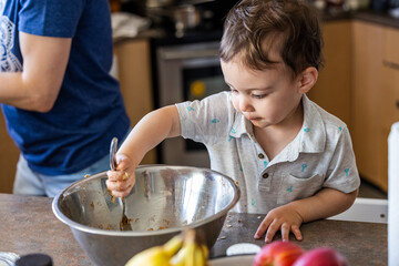 Young Boy Toddler Cooking in Kitchen at Home with Mixing Bowl
