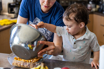Mother and Toddler Cooking Together in the Kitchen at Home