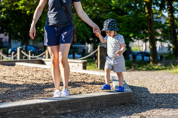 Boy Toddler Playing in Vancouver Park with Adult Guidance, BC, Canada