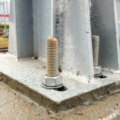 Connection of the column flange and the concrete base with an anchor bolt and nut.