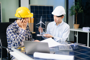 Business people having consultation about wind energy at company office. Business team discussing about windmill and alternative green energy.