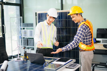 Engineers discuss solar panels and turbines in office, working on clean energy design, sustainable...