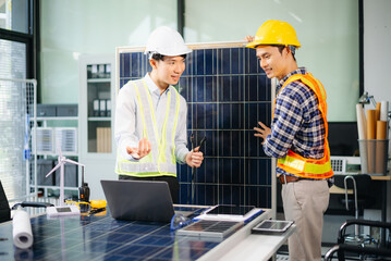 Engineers discuss solar panels and turbines in office, working on clean energy design, sustainable...